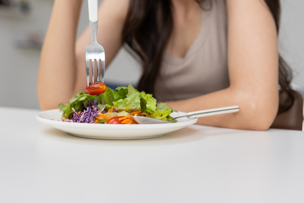 Osoba jede svežu salatu bogatu vlaknima koja pomaže kod problema sa varenjem i hemoroidima